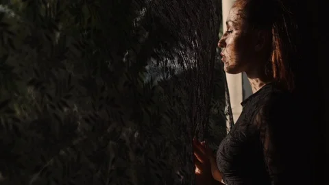 Beautiful woman's portrait with lace pattern shadow and sun light on her face Stock Footage 90173796
