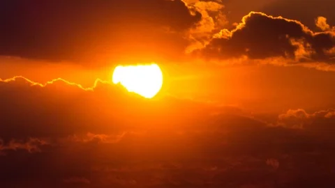 Beautiful yellow cloudscape with large sun Stock Footage 98304943