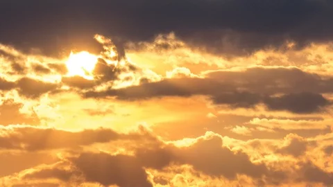 Beautiful yellow cloudscape with large sun Stock Footage 98407641