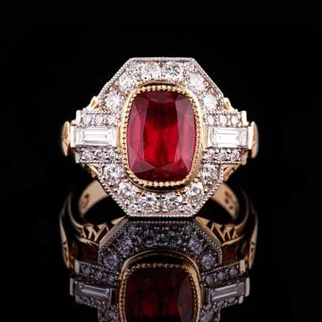 Beautiful yellow gold ring with a ruby on a black background 스톡 사진