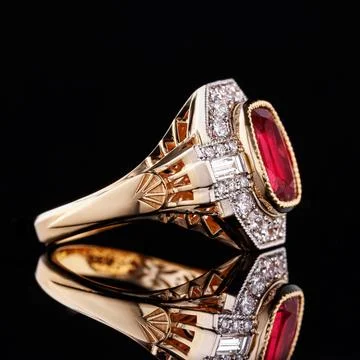 Beautiful yellow gold ring with a ruby on a black background 스톡 사진