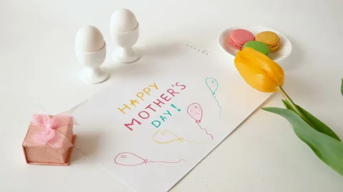 Beautiful yellow tulips bunch, present box, eggs, french macaroni  Stock Footage 127053285
