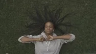 Beautiful Young African American Girl Resting On The Grass. Top View Stock Footage