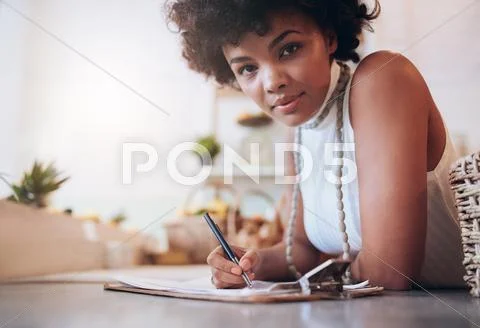 Beautiful young african woman working in a juice bar Stock Photos
