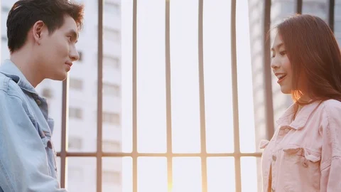 Beautiful Young Asian Couples while man giving roses to his surprise romantic Stock Footage 124100156