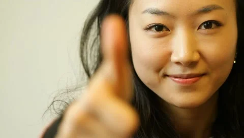 Beautiful young asian woman smiling with thumb up Stock Footage