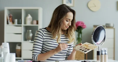 Beautiful young blogger recording a tutorial beauty video on how using eye Stock Footage 92506842