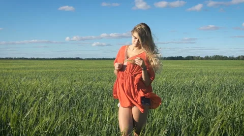 Beautiful young blond woman with the sexy look standing and enjoying herself at Stock Footage