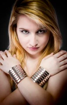 Beautiful young blonde woman with jewelry and silver bracelets Stock Photos