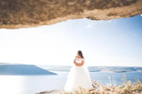 Beautiful young bride posing on the background sea Stock Photos