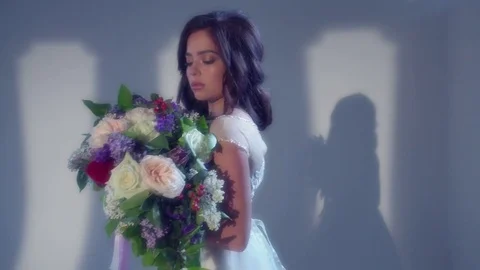 Beautiful young bride is posing with wedding bouquet Stock Footage 77333482