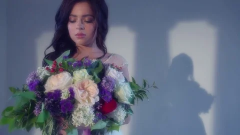 Beautiful young bride is posing with wedding bouquet Stock Footage 77333489