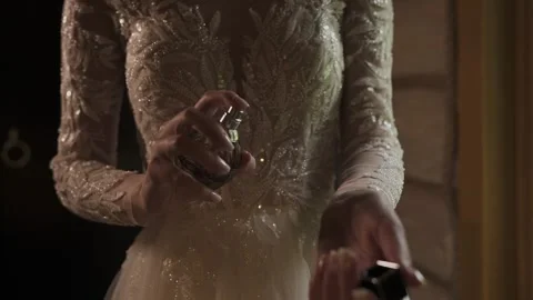 A beautiful young bride sprays herself with perfume Stock-Footage 328315022