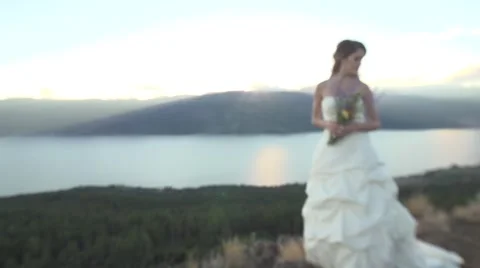 Beautiful Young Bride in White Wedding Dress with Mountain top Sunset Stock Footage 67904650