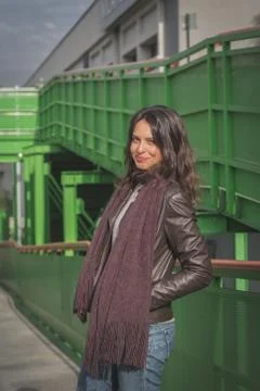 Beautiful young brunette posing on a bridge Stock Photos