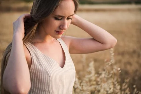 Beautiful young caucasian woman with long blond hair touching her hair on a Stock Photos