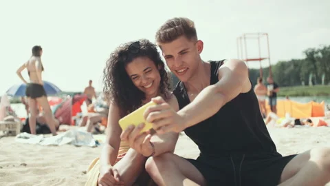 Beautiful young cheerful couple making selfie on a beach. Stock Footage 94954853