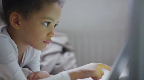 Beautiful young child interacting with a tablet device in slow motion Stock Footage