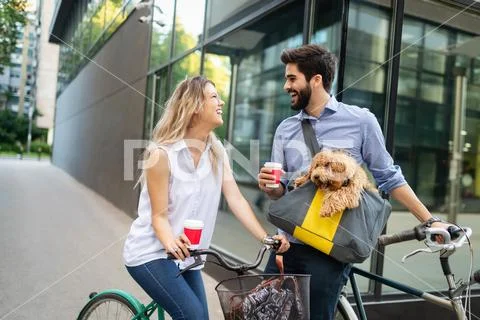 Beautiful young couple on a bike ride on a sunny day in the city Stock Photos