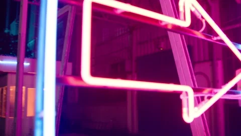Beautiful young couple dancing and doing movement near bar neon sign lights Vídeos de archivo 201545338