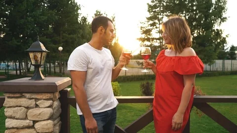 Beautiful young couple drinking wine on a terrace Stock Footage 78740404