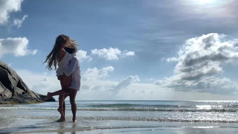 Beautiful young couple having fun on the tropical beach Stock Footage 135705992