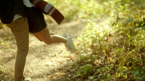 Beautiful young couple hugging on walking in the forest Stock Footage 96233687