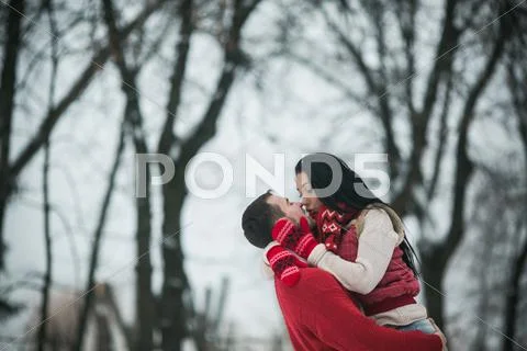 Beautiful young couple kissing in the park Stock Photos