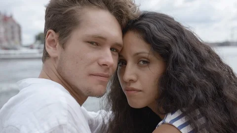 A beautiful young couple smiling at the camera in a harbour in Stockholm centre. Video stock 115992393