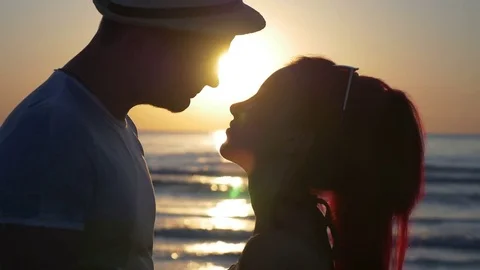Beautiful young couple teasing one another and kissing at sunset Video stock 71309485
