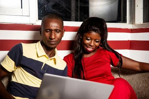 Beautiful young couple using a computer Stockfoto's