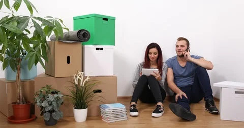 Beautiful Young Couple Work on Digital Tablet Positive Dialogue Phone New House Stock Footage 85502483