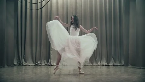 A beautiful young dancer is training on stage. Stock Footage 155982695