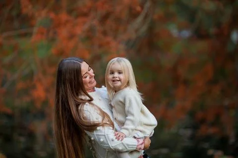 Beautiful young dark haired mother plays with her little daughter 3 years old Stock Photos