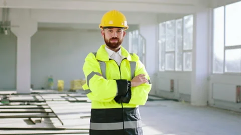 Beautiful young engineer man posing to the camera at construction site he Stock Footage 168632996