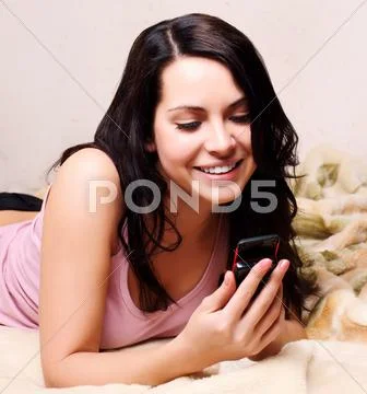 Beautiful young female holding a mobile , reading a message Stock Photos