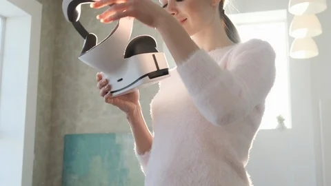 Beautiful young female playing game in virtual reality glasses. Video stock 102733711