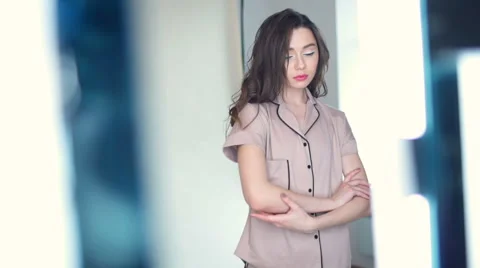 Beautiful young female posing in pyjama in studio slow motion Video stock 62199067
