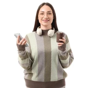Beautiful young female programmer with mobile phone and cup of coffee on whit 库存照片