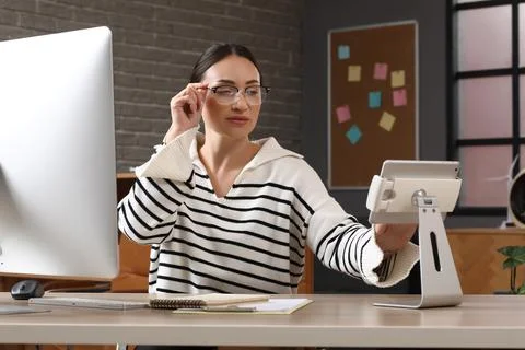 Beautiful young female programmer working with tablet computer in modern offi Stock Photos