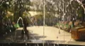 Beautiful young female student walking in park. Hot summer day in college campus HD Footage
