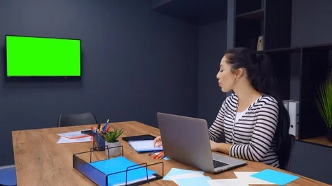 Beautiful young female trainee working on her laptop Stock Footage 122364783