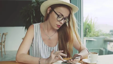 Beautiful young female using mobile phone for education in cafe. Stock Footage 74367720