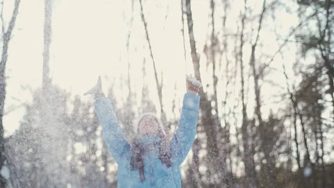 A beautiful young girl with dark straight hair and blue eyes in a warm hat, glov 库存影片 233340887