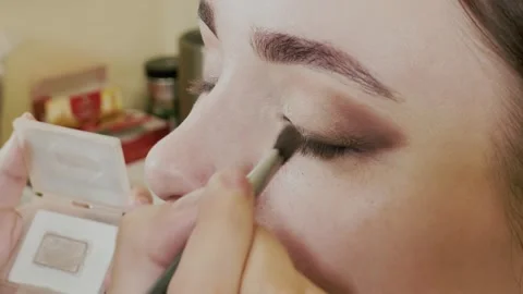 Beautiful young girl doing makeup in a beauty salon Stock Footage 337741738