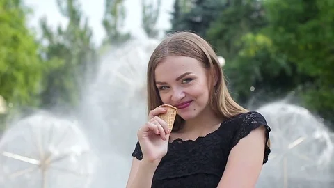 Beautiful young girl eating ice cream Stock Footage