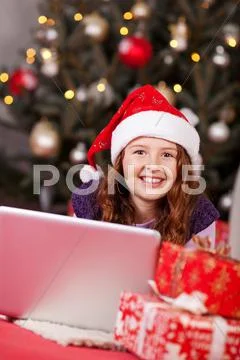 Beautiful young girl wearing a red santa hat Stock Photos