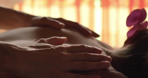 A beautiful young girl (woman) doing a back massage in the spa salon Stock Footage