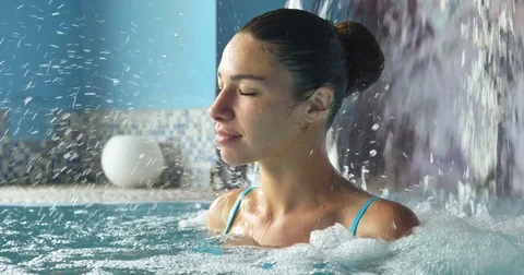 Beautiful young girl (woman) relaxed in a hydromassage bath Stock Footage