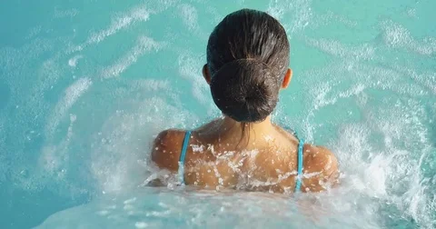 Beautiful young girl (woman) relaxed in a hydromassage bath Stock Footage